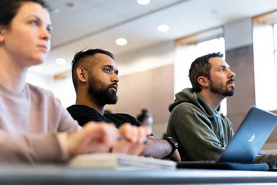 Photo of a three Chatham University students in a classroom, 注意屏幕外的教练